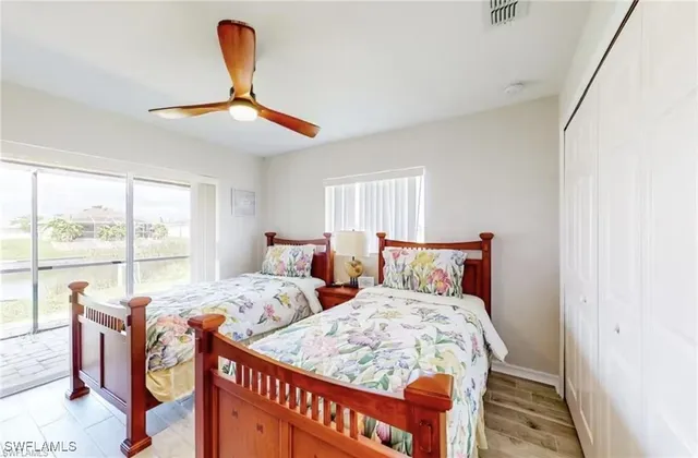 a bedroom with two beds and window