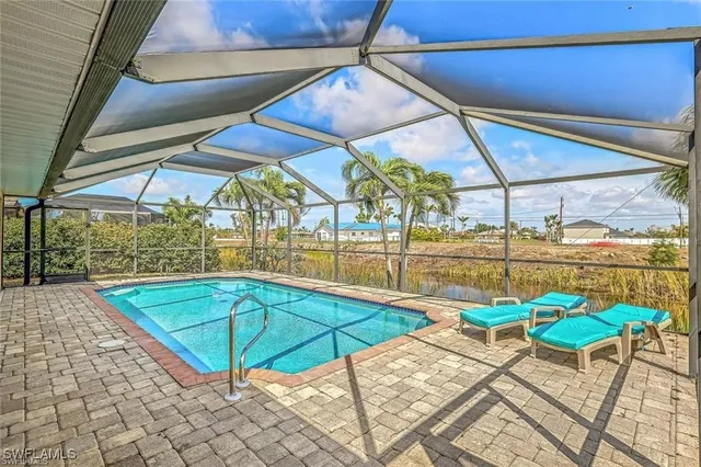a patio with a table and chairs under an umbrella