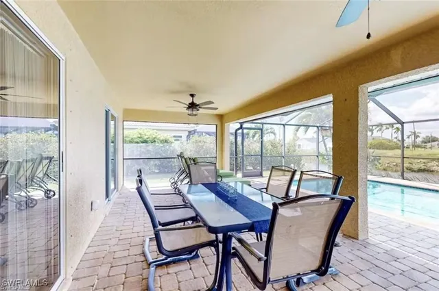 a view of a dining room with furniture large windows and wooden floor