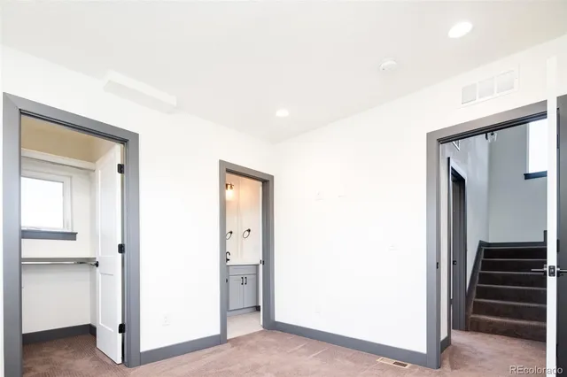 a view of a hallway with entryway and stairs