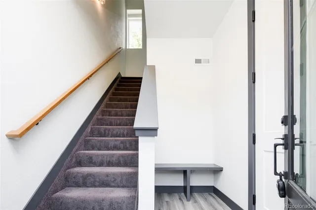 a view of entryway and hall with wooden floor