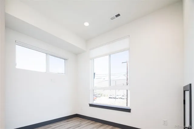 a view of a hallway with an empty room and a window
