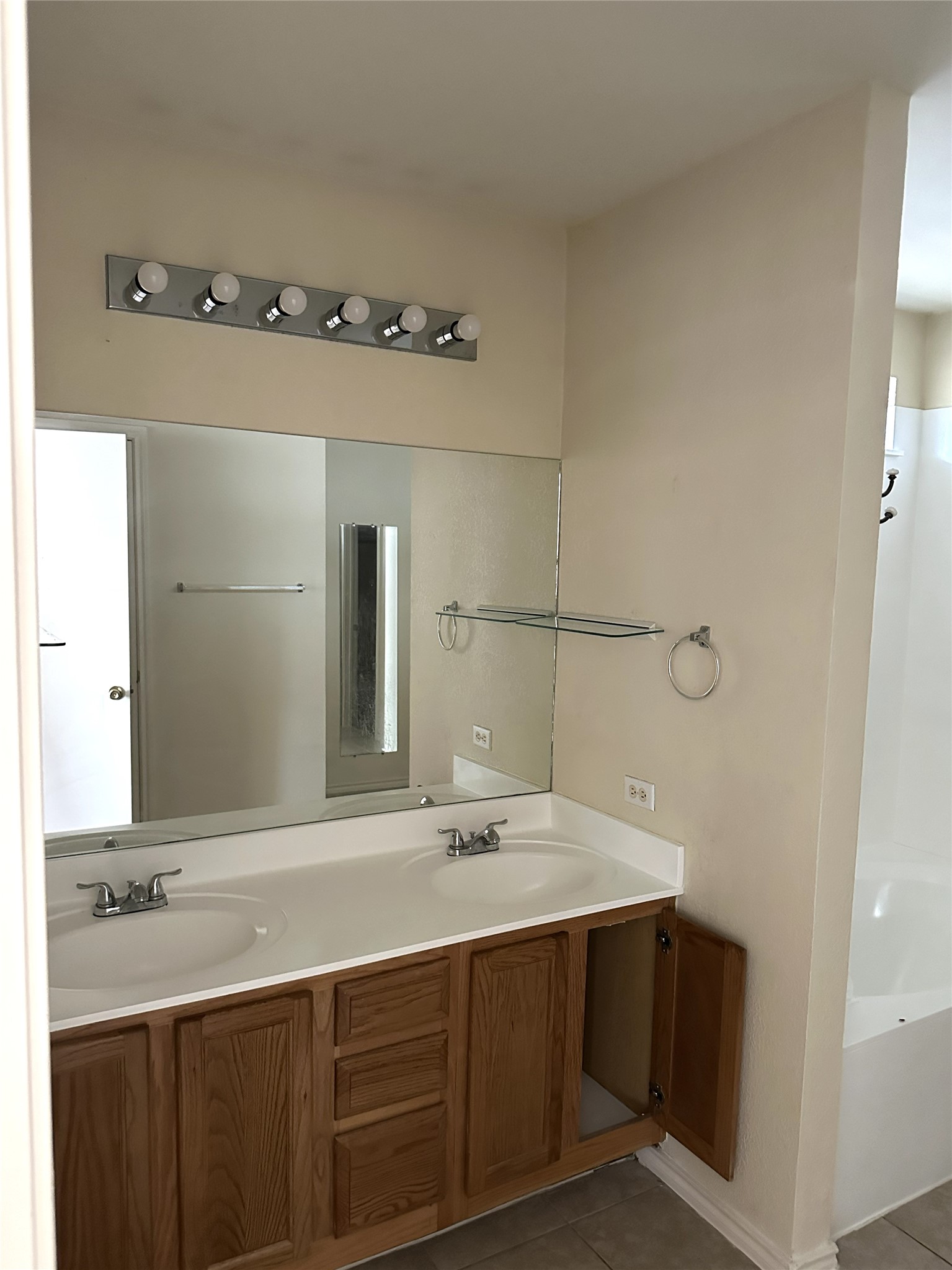 13915 Randalstone Drive Pflugerville, TX 78660 - Photo 11 of 19 Bathroom featuring double vanity and light tile patterned floors