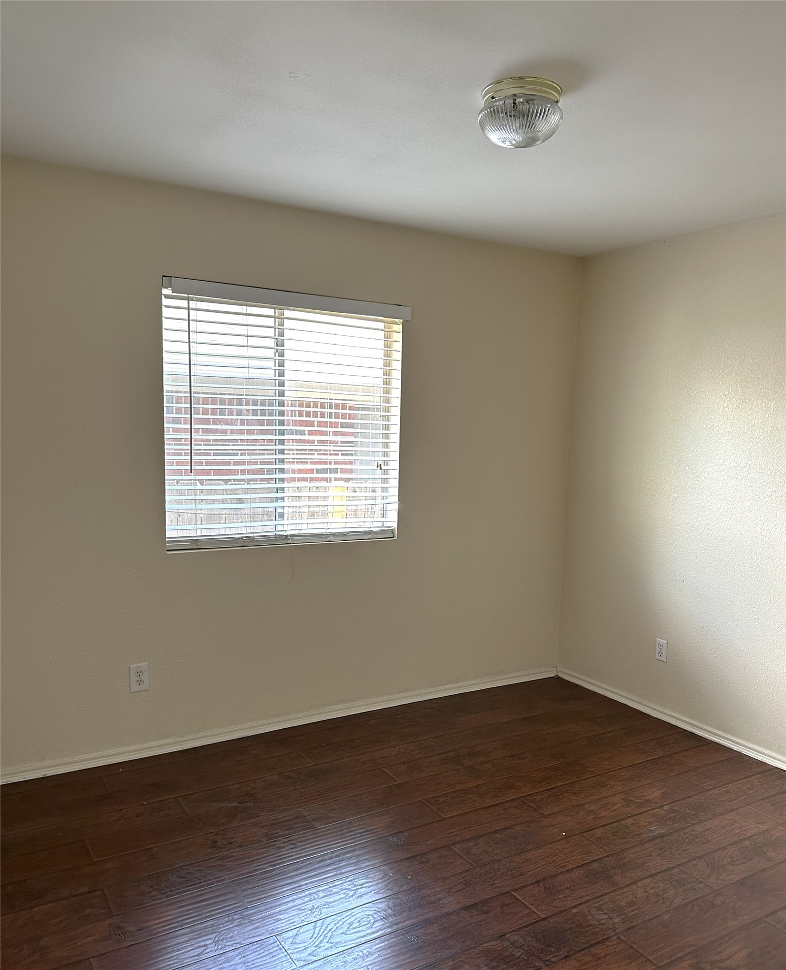 13915 Randalstone Drive Pflugerville, TX 78660 - Photo 14 of 19 Unfurnished room featuring baseboards and dark wood-style floors