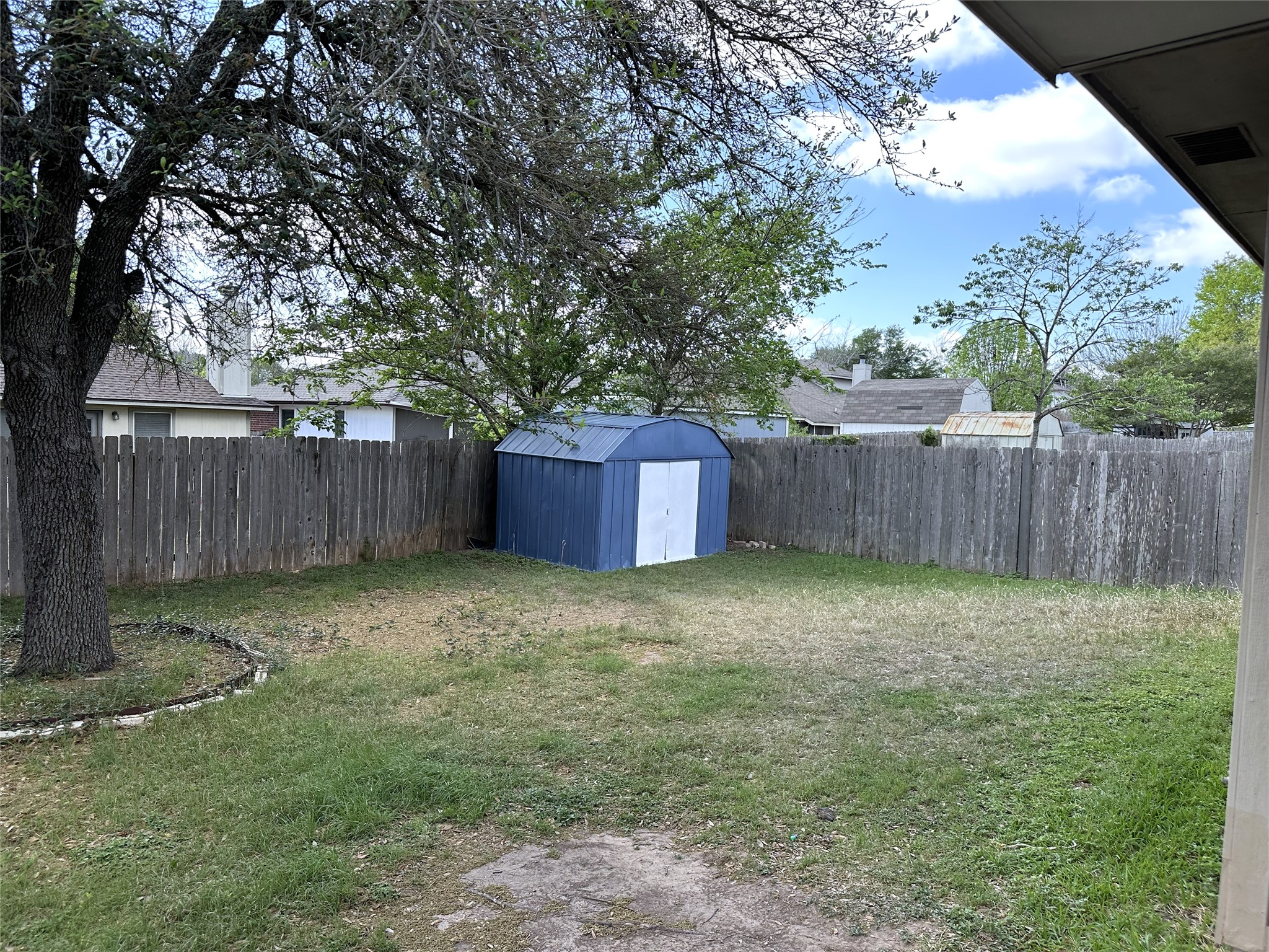 13915 Randalstone Drive Pflugerville, TX 78660 - Photo 17 of 19 Fenced backyard with a storage shed