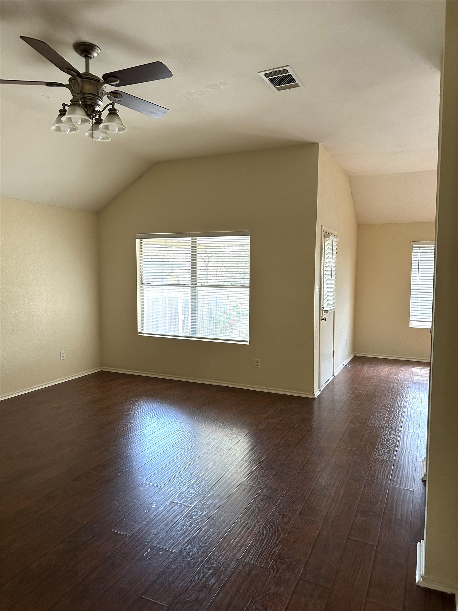 13915 Randalstone Drive Pflugerville, TX 78660 - Photo 4 of 19 Unfurnished room featuring a ceiling fan, dark wood-style flooring, and vaulted ceiling