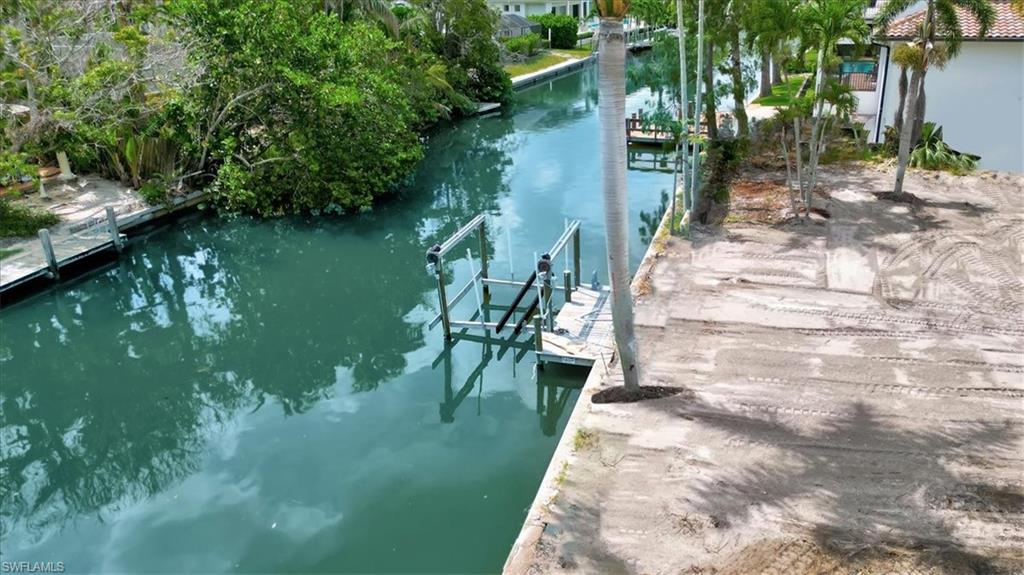 5186 Seashell Avenue Naples, FL 34103 - Photo 4 of 8 a view of a lake with a yard