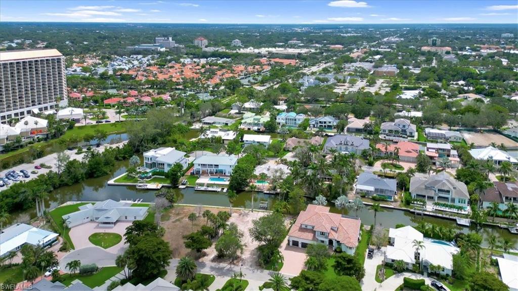 5186 Seashell Avenue Naples, FL 34103 - Photo 6 of 8 an aerial view of lake and residential houses with outdoor space