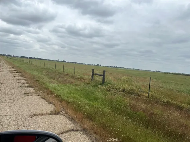 a view of a field and an lake
