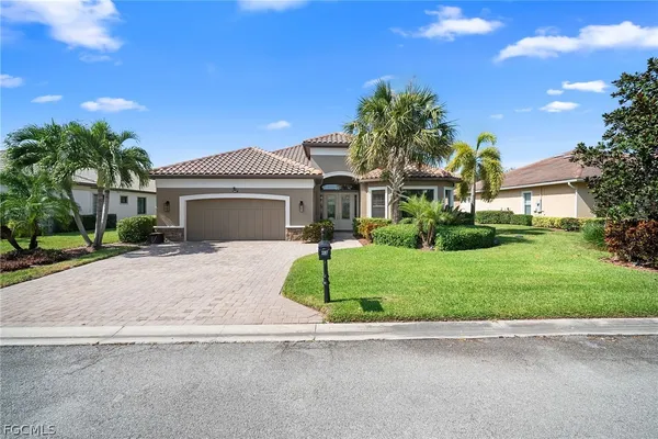 a front view of a house with a yard and garage