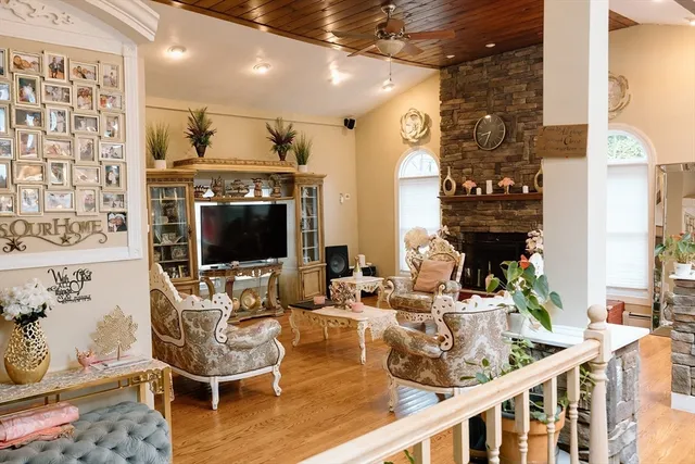 a living room with fireplace furniture and a flat screen tv
