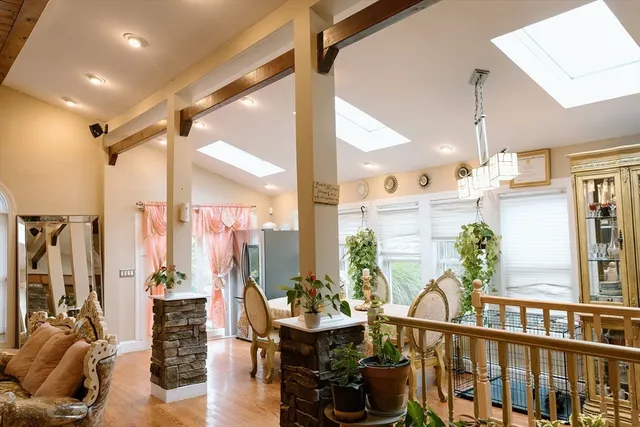 a view of a living room with furniture and floor to ceiling windows