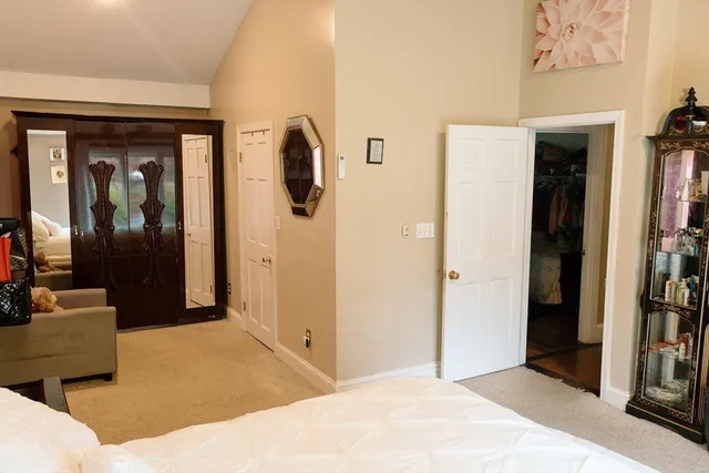 a bedroom with a bed and a mirror