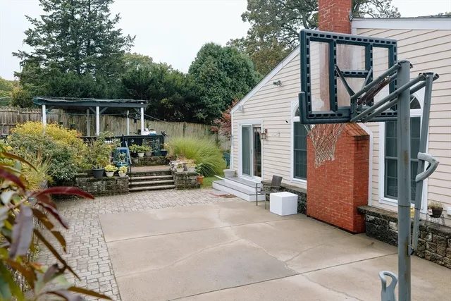 a view of two chairs and a table in the patio