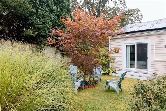 a view of a small house with backyard