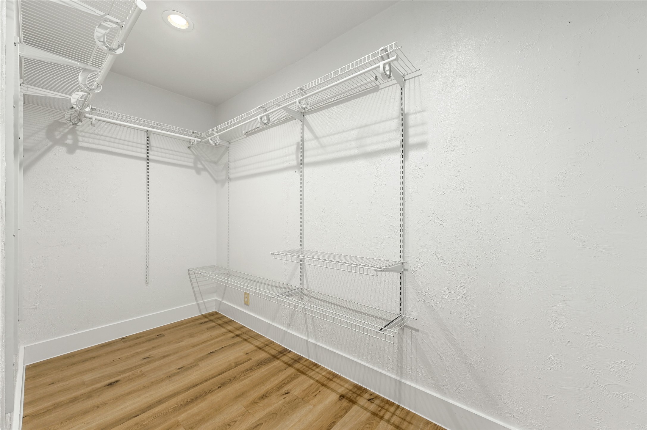 4808 Wind River Road Austin, TX 78759 - Photo 10 of 21 Adjustable wire shelving and wood-look flooring maximize organization in this functional storage space.