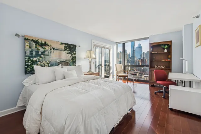 a bed room with a bed and a large window