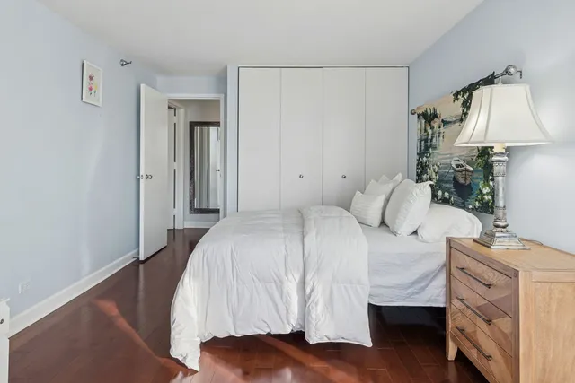 a bedroom with a bed and a lamp