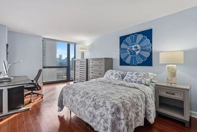 a bedroom with a bed and a desk