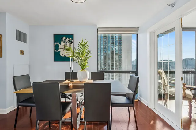 a view of a dining room with furniture and wooden floor