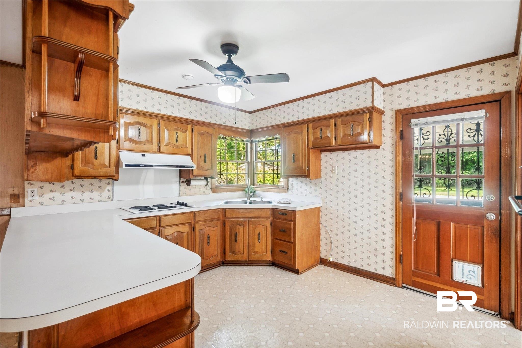1252 Helm Circle Mobile, AL 36693 - Photo 5 of 18 Kitchen featuring light tile patterned flooring, ceiling fan, white electric stovetop, sink, and kitchen peninsula