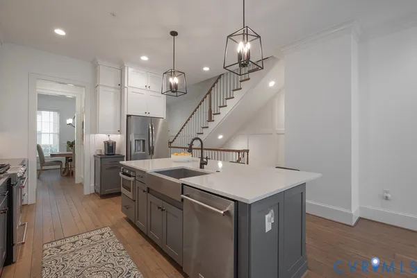 a kitchen with a dining table chairs and white cabinets