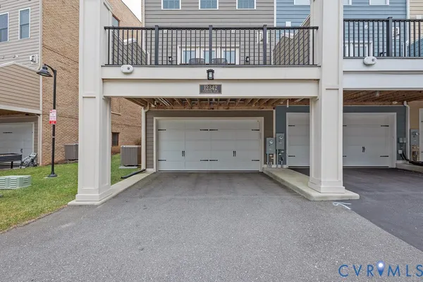 a view of a backyard with table and chairs under an umbrella with a barbeque