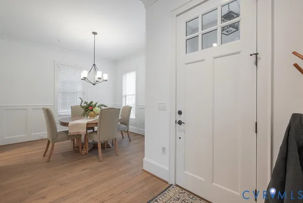 a view of a dining room with furniture and wooden floor