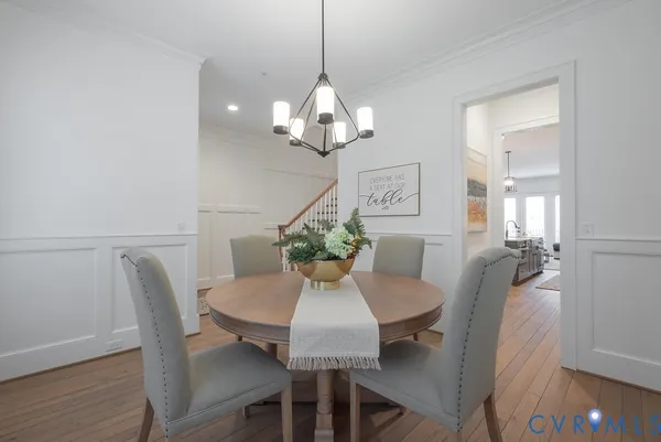 a view of a dining room with furniture and chandelier