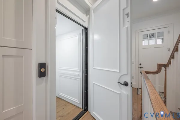 a view of a hallway with wooden floors and closet