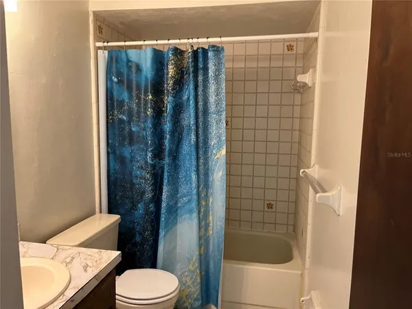 a bathroom with a shower and a toilet
