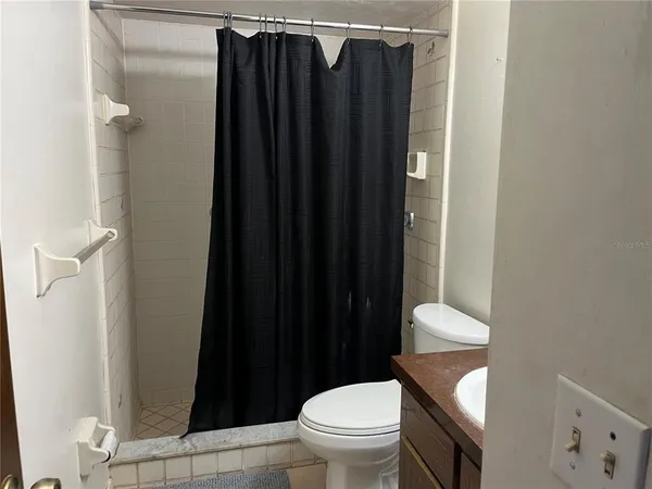 a bathroom with a toilet and a shower