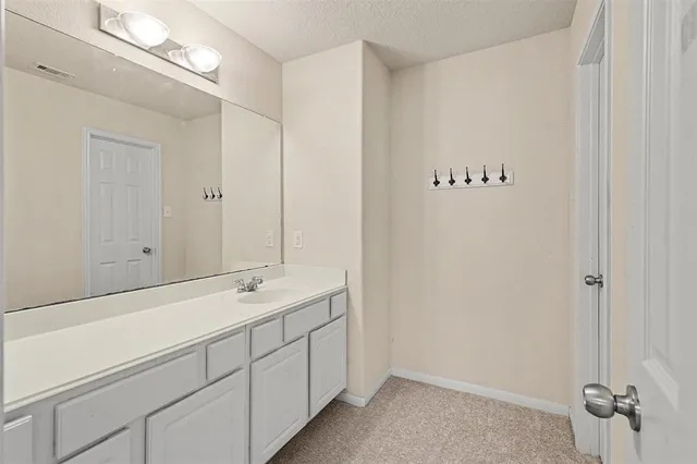 a bathroom with a double vanity sink and mirror