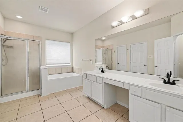 a spacious bathroom with a shower a sink and a bathtub