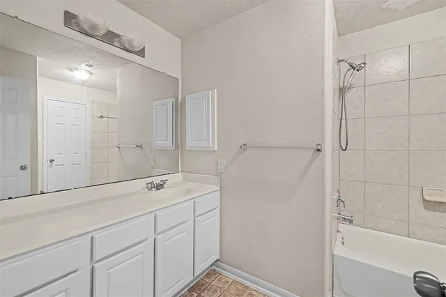 a bathroom with a shower and a sink