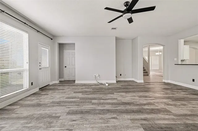 a view of empty room with ceiling fan