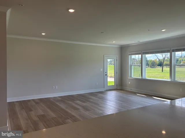 an empty room with large windows
