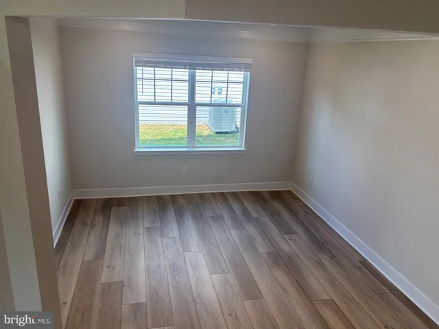 a view of a room with wooden floor and window