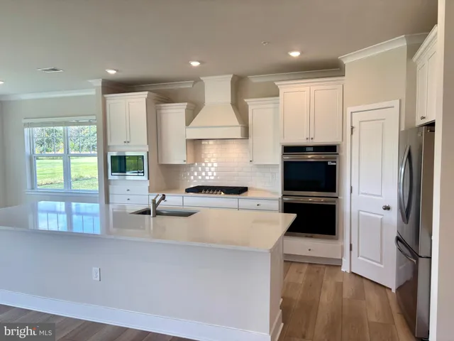 a kitchen with a refrigerator a stove a sink and a cabinets