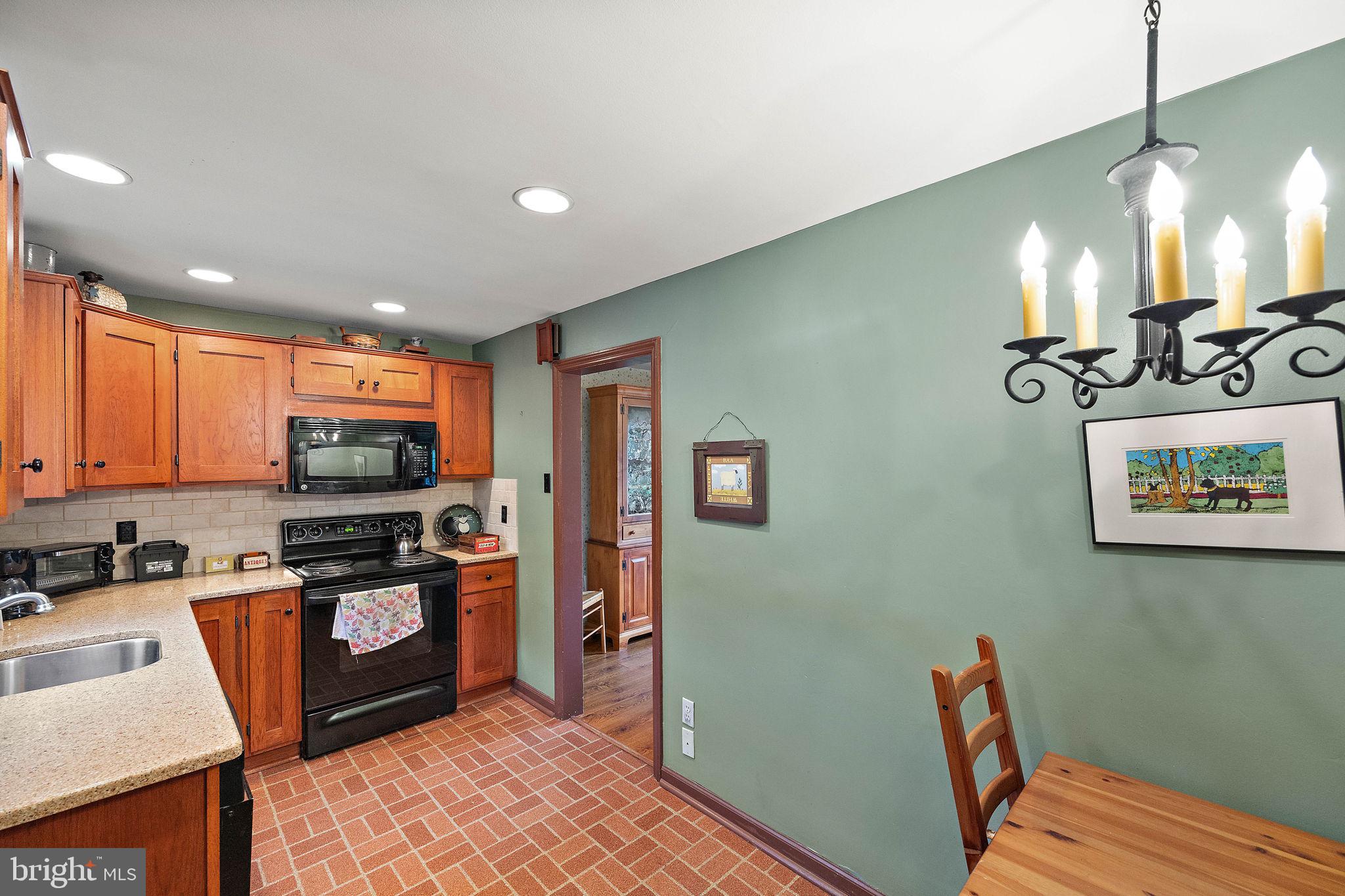 227 Pine Ridge Road Havertown, PA 19083 - Photo 17 of 36 a kitchen with stainless steel appliances granite countertop a stove top oven a sink and a granite counter tops
