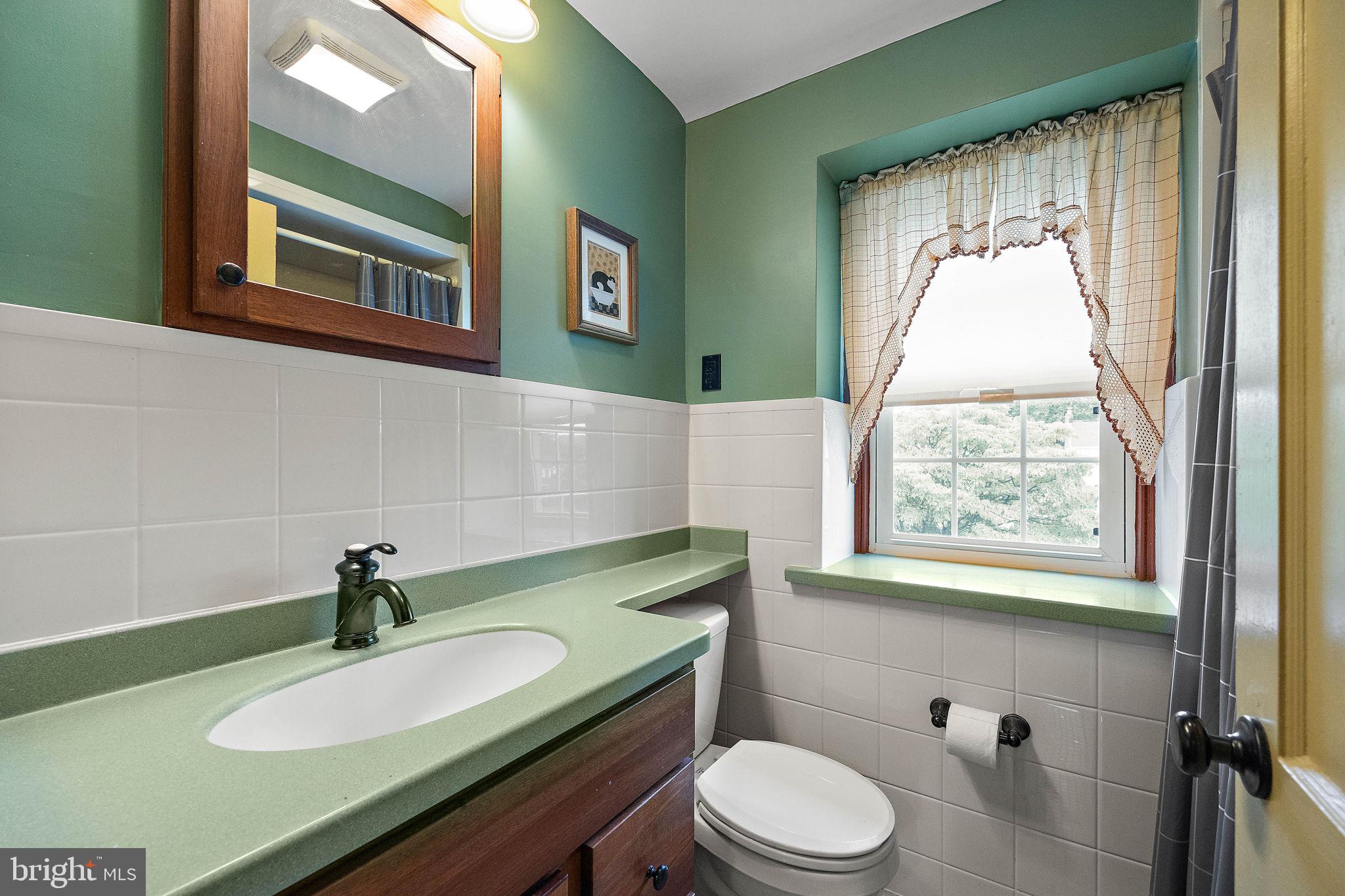 227 Pine Ridge Road Havertown, PA 19083 - Photo 22 of 36 a bathroom with a sink toilet and a mirror