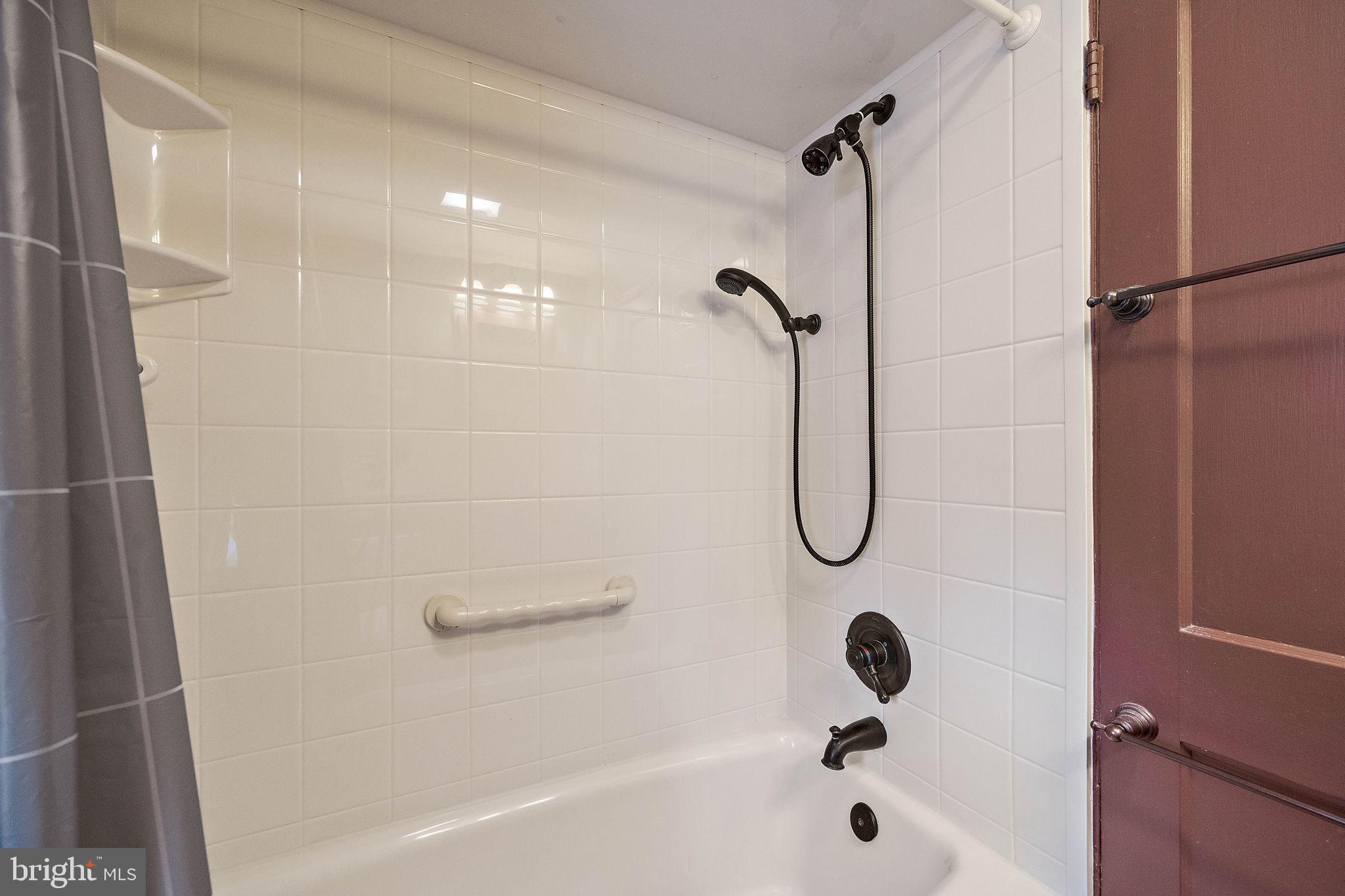 227 Pine Ridge Road Havertown, PA 19083 - Photo 23 of 36 a bathroom with a bath tub with a shower
