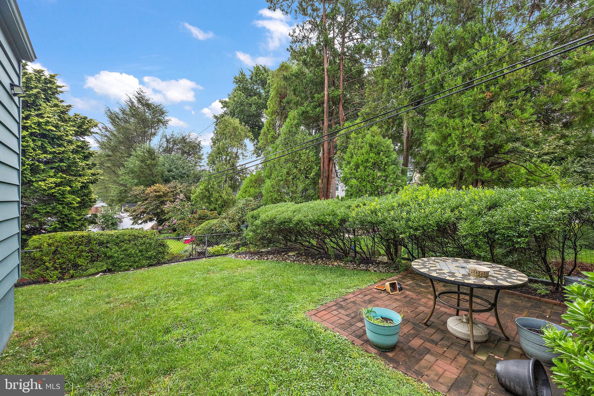 227 Pine Ridge Road Havertown, PA 19083 - Photo 29 of 36 a view of a backyard with table and chairs and potted plants