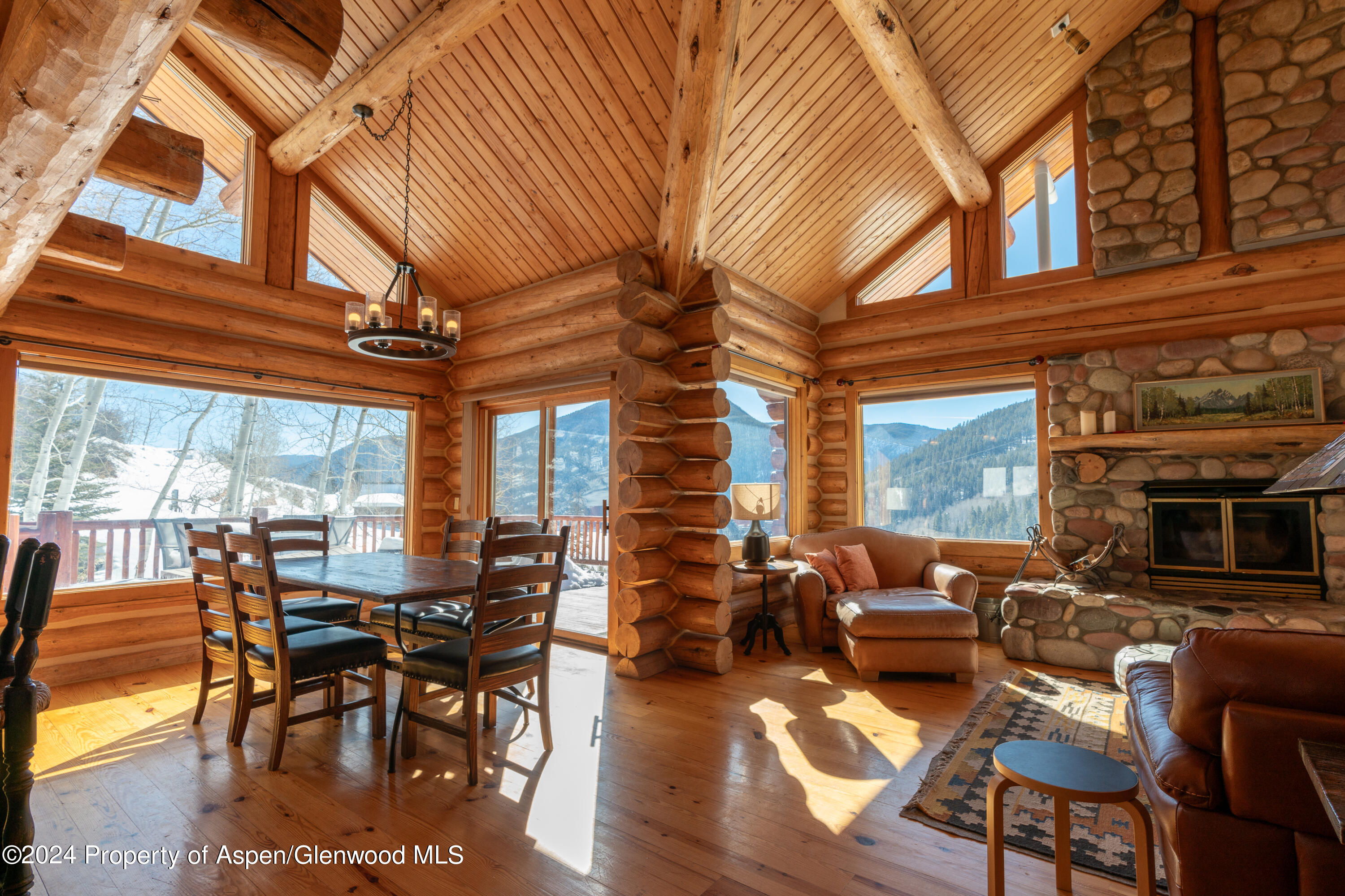 491 McLaughlin Lane Basalt, CO 81621 - Photo 1 of 56 a view of a patio with couches table and chairs with wooden floor and fence