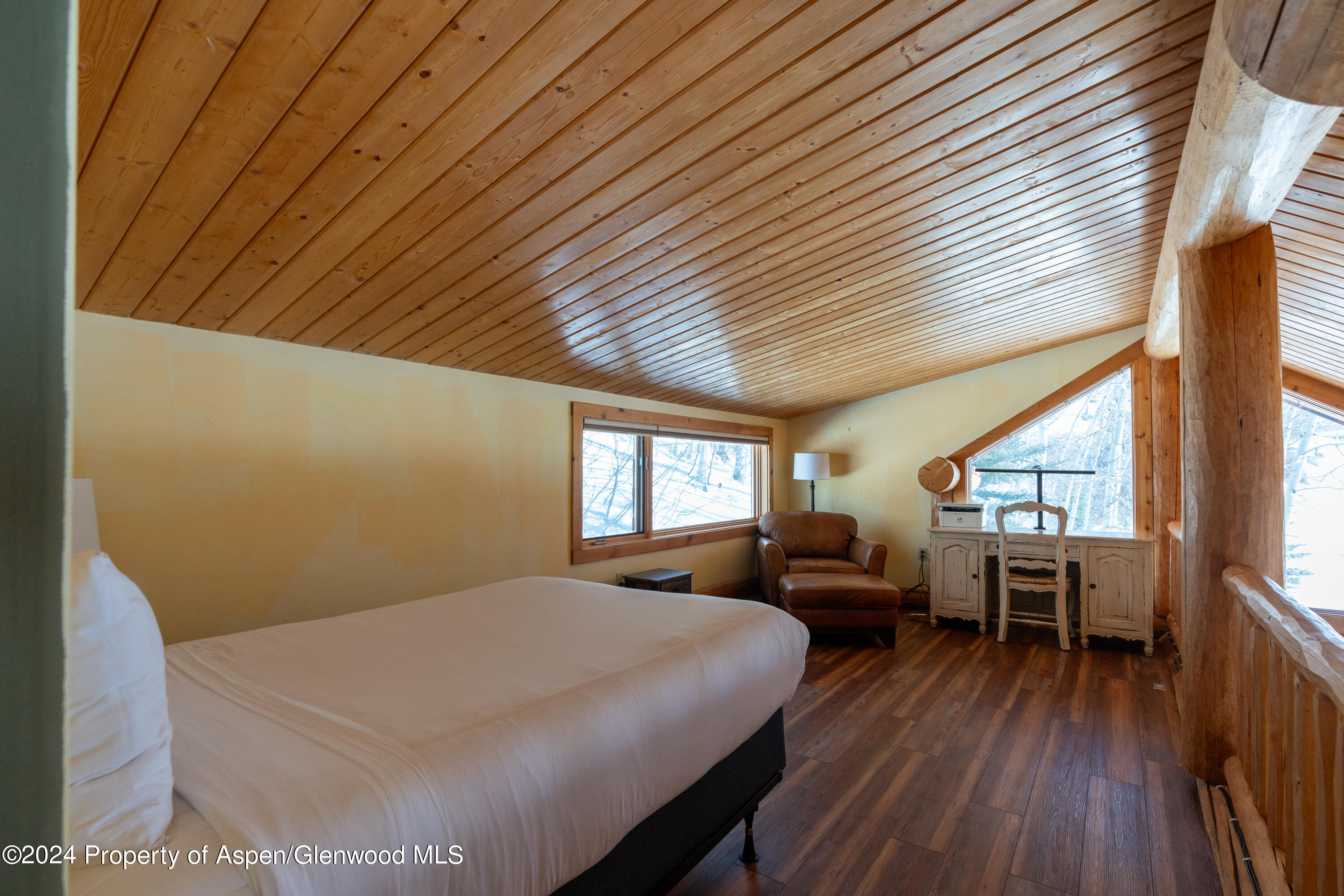491 McLaughlin Lane Basalt, CO 81621 - Photo 29 of 56 a bed room with a bed window and wooden floor