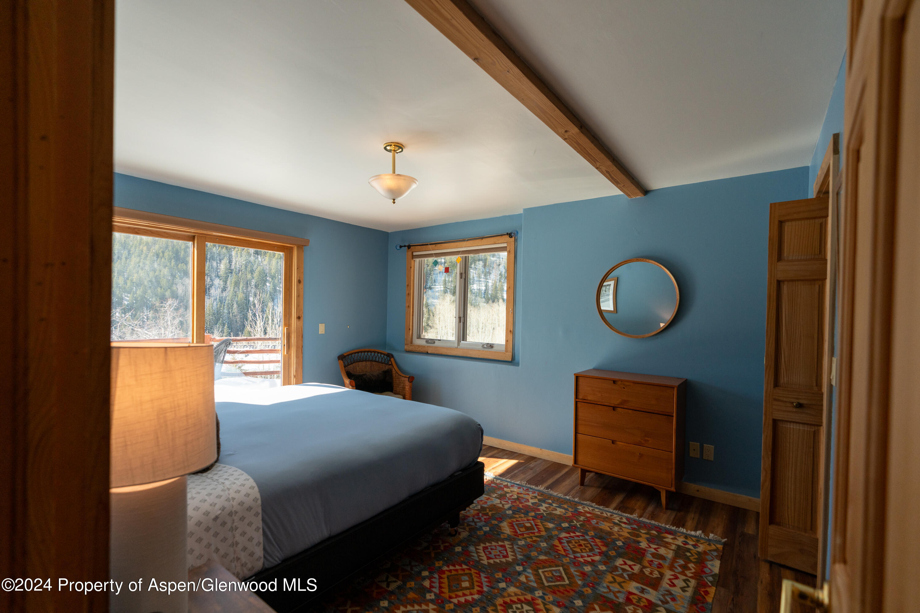 491 McLaughlin Lane Basalt, CO 81621 - Photo 42 of 56 a bedroom with a bed and window with lamp