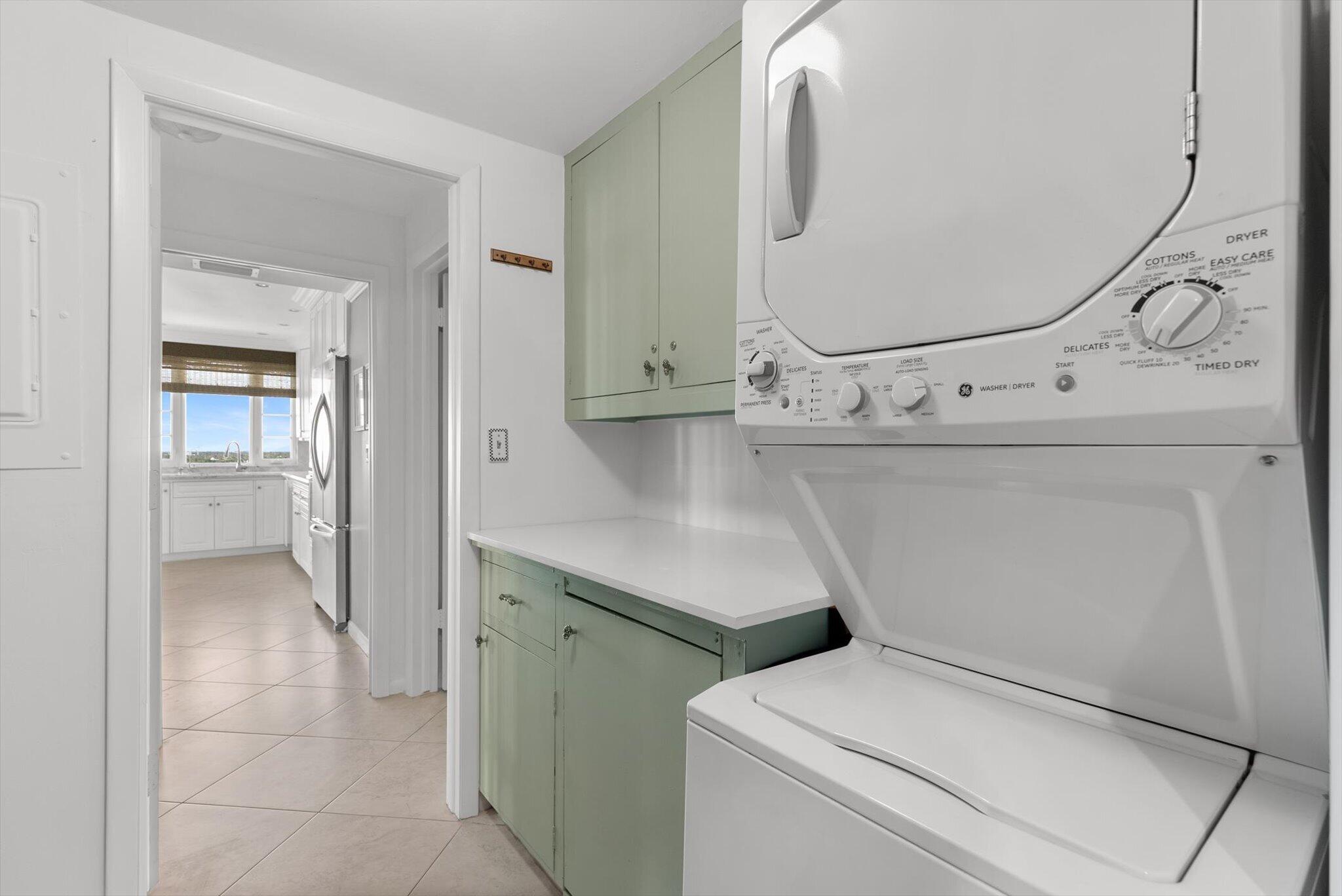 50 E Road, Unit 12A Delray Beach, FL 33483 - Photo 29 of 47 a utility room with cabinets washer and dryer