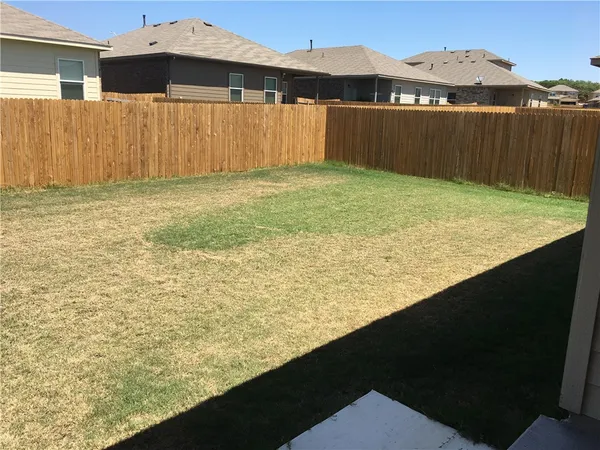 a bathroom with a granite countertop shower and a toilet