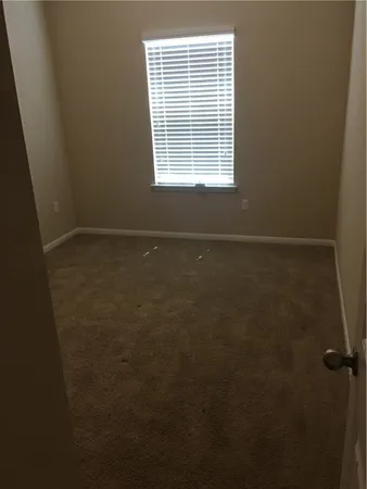 a kitchen with a stove top oven and refrigerator