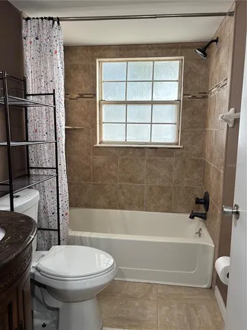 a bathroom with a toilet and a bathtub
